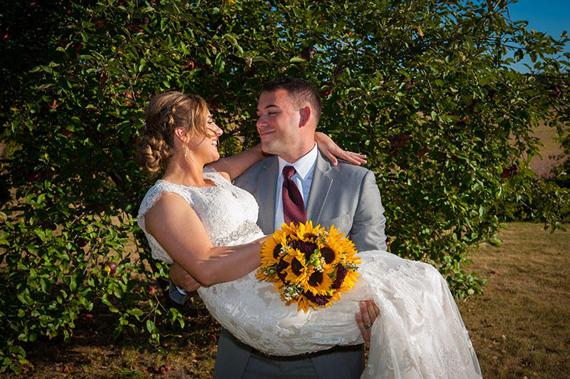 Bride and Groom pose near the trees at the wedding event venue, The Barn 1893 Hampshire, IL