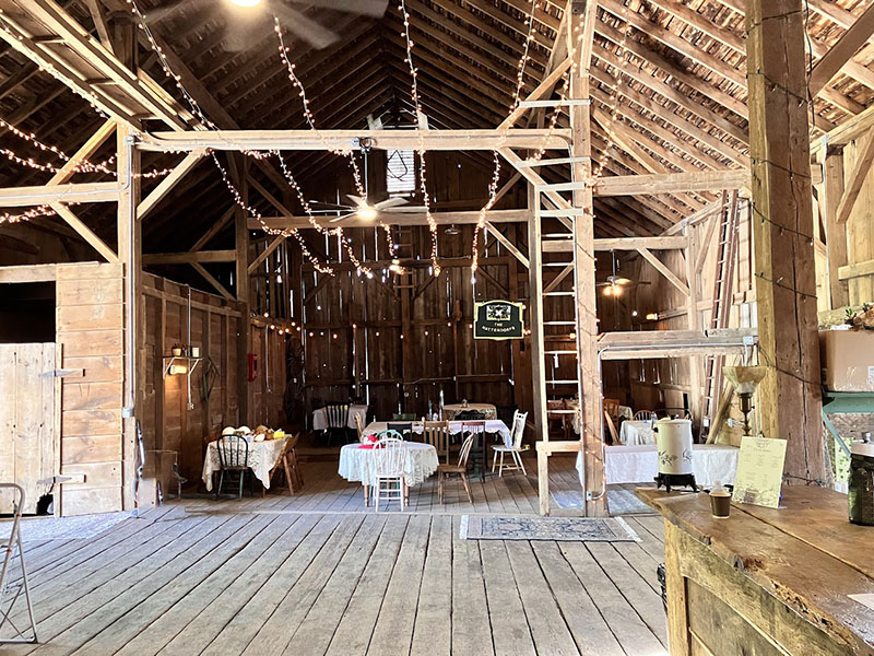 Inside the Barn 1893 with dressed tables at the event venue, Hampshire Illinois